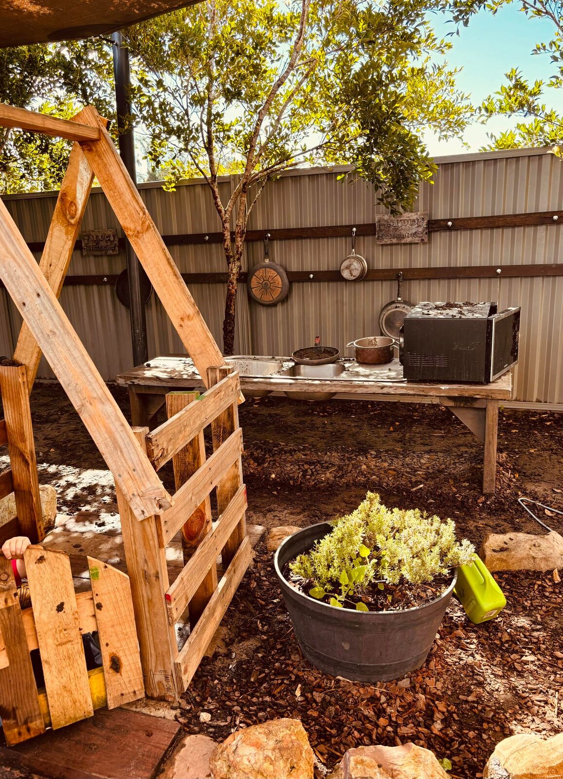 Wooden A-frame climbing structure in the natural outdoor play yard