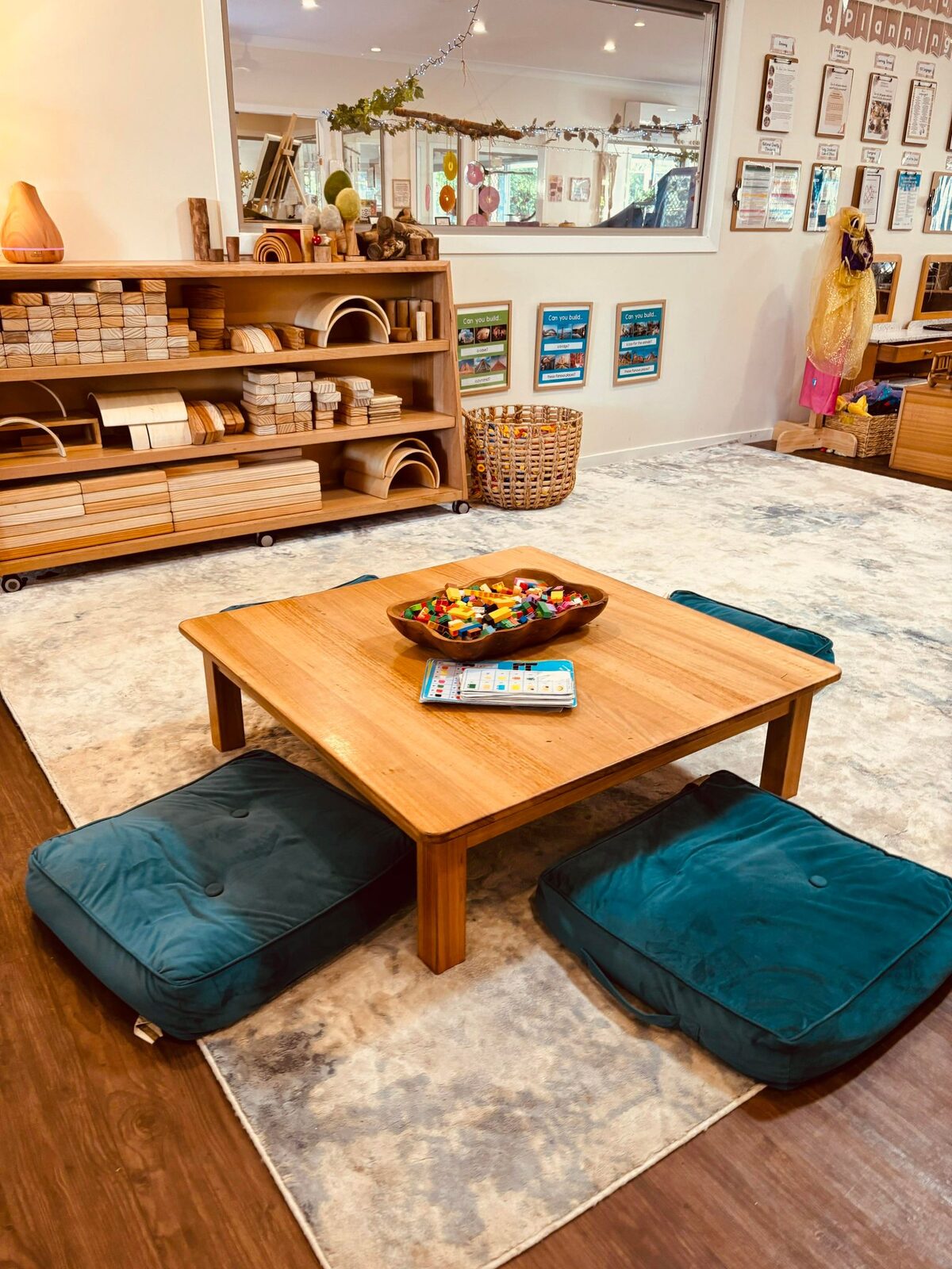 Cosy indoor reading and rest corner with floor cushions and a low timber table