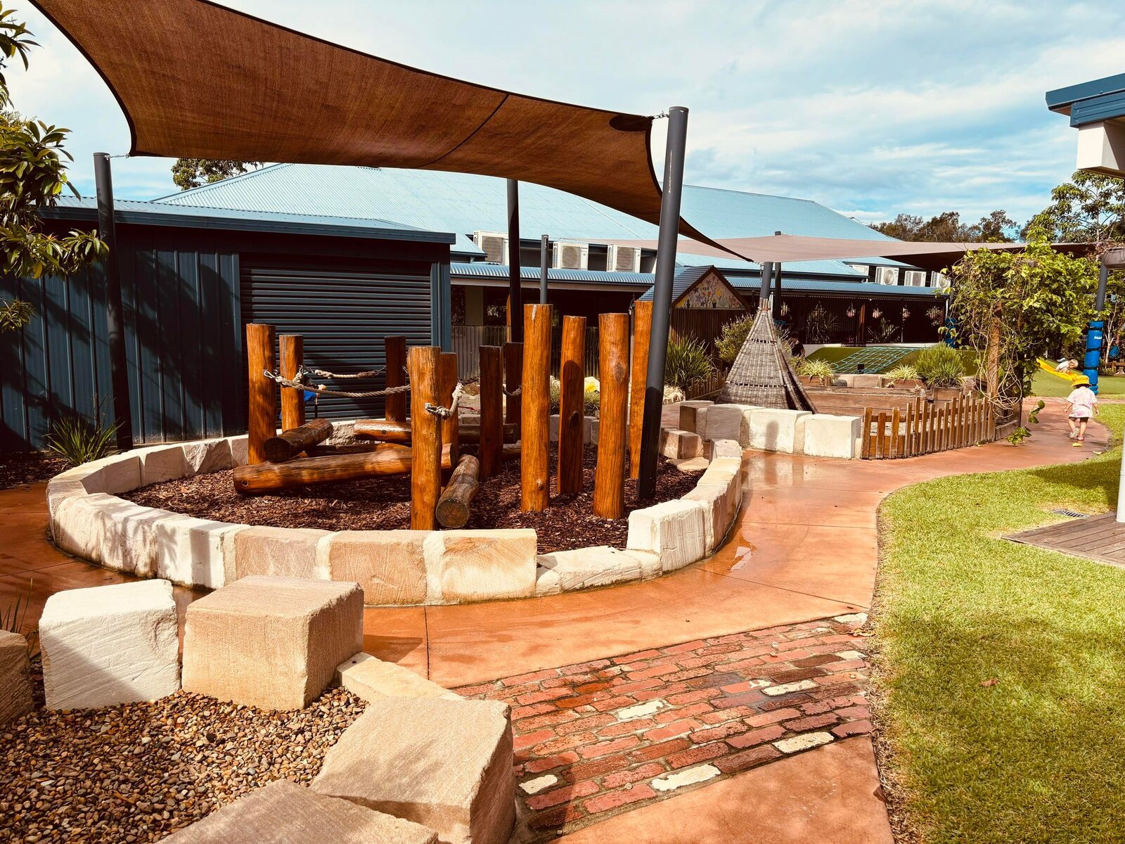 Shaded stone seating circle for outdoor group time and storytelling