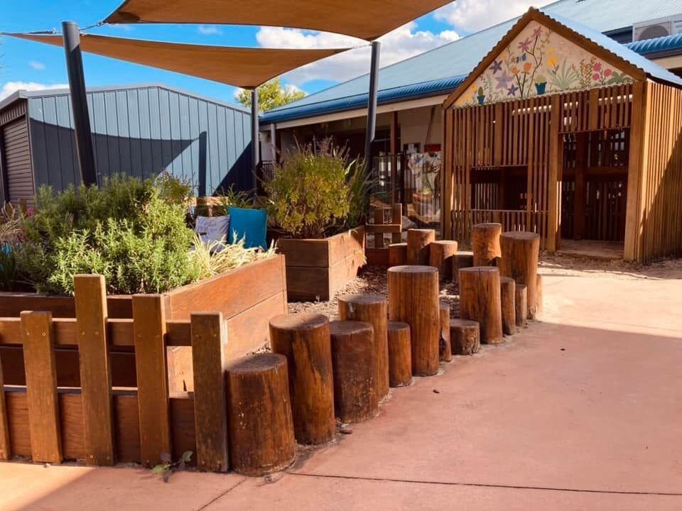 Timber-lined walkway connecting classrooms to the outdoor environment